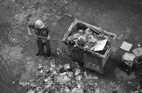 Archive image showing a skip outside a residential street in Archway with recycling icons