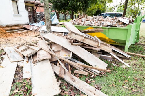 Skip hire vehicle parked on Archway street outside terraced houses