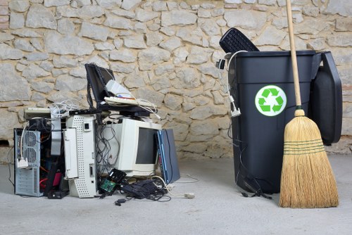 People loading waste into a grab hire container