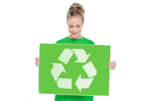 Workers segregating waste in a commercial skip